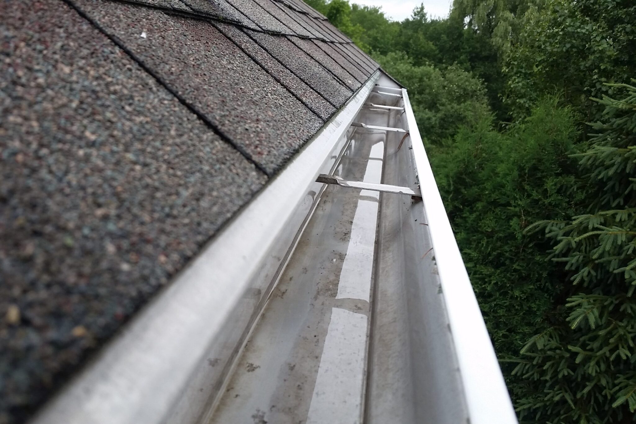 Clean, empty gutter running along a home's roofline after service