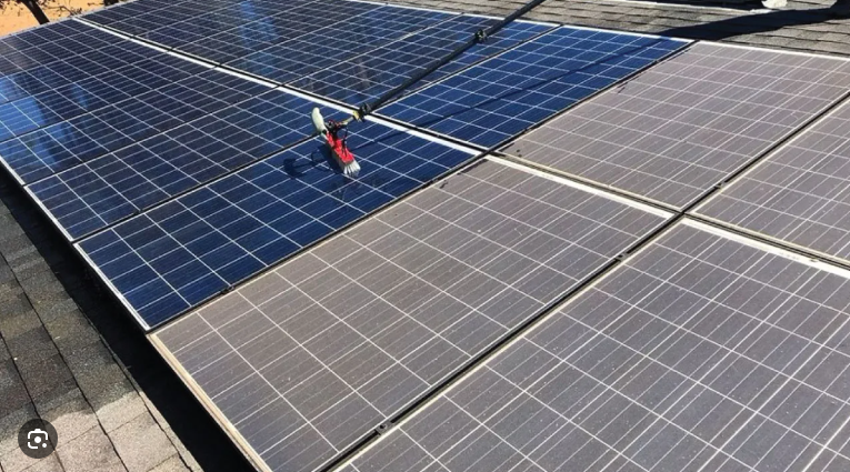 Before and after contrast on a solar array — a cleaned section next to a dusty one