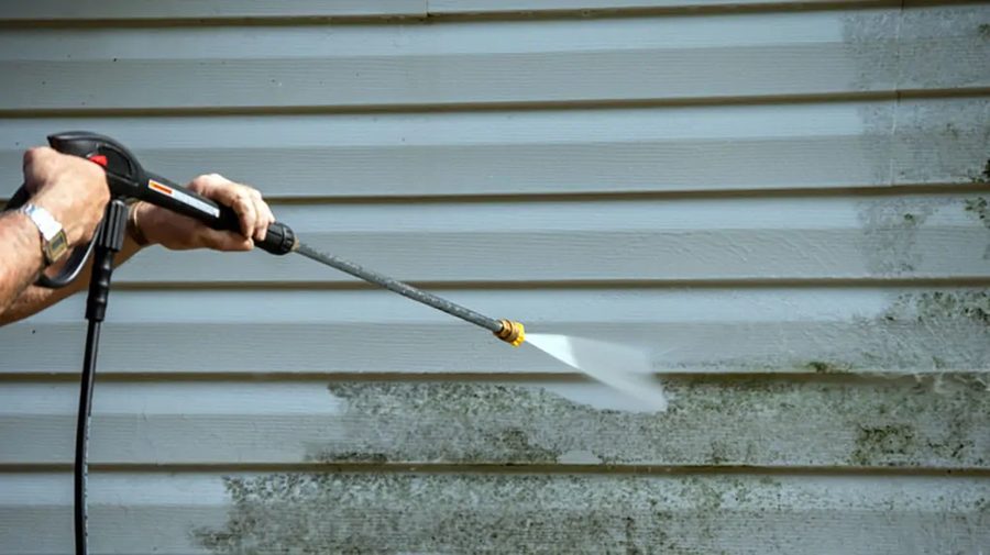 Pressure washing dirt and grime off vinyl house siding in Vallejo