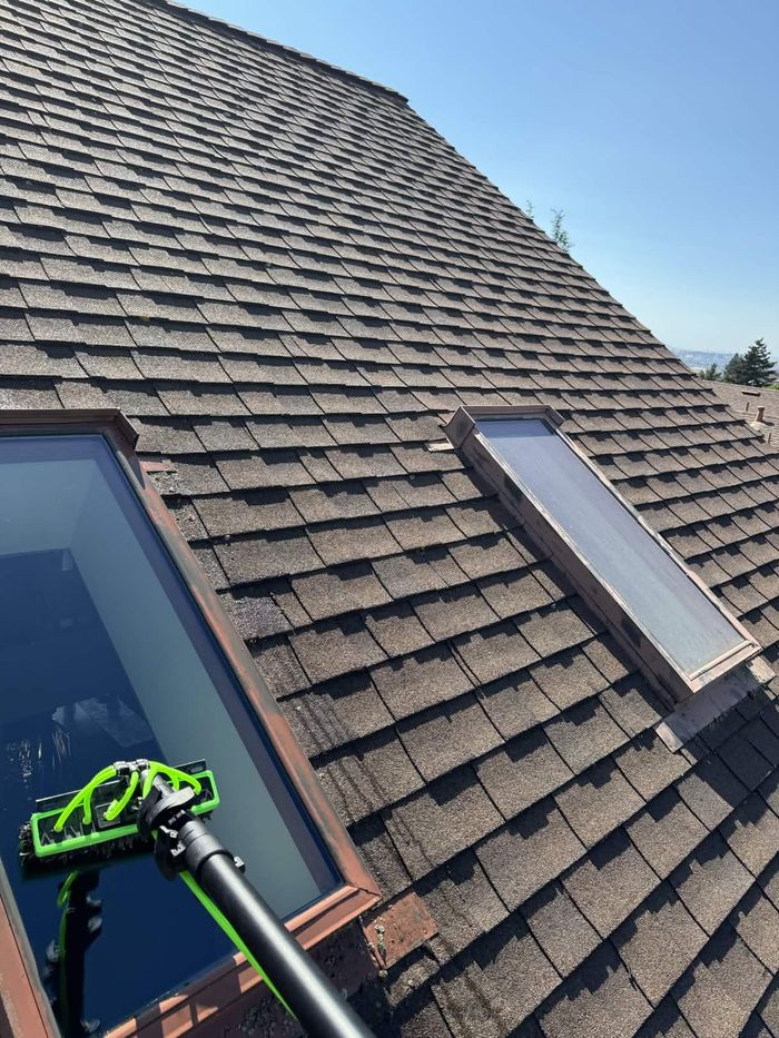 Perfect Pane cleaning a rooftop skylight with a long-handled tool in Suisun City