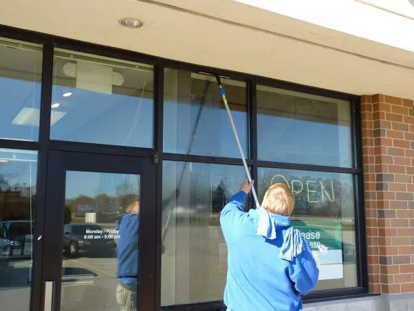 Suisun City storefront window cleaning with an OPEN sign visible