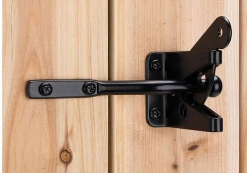 Latched gate hardware on a wood fence